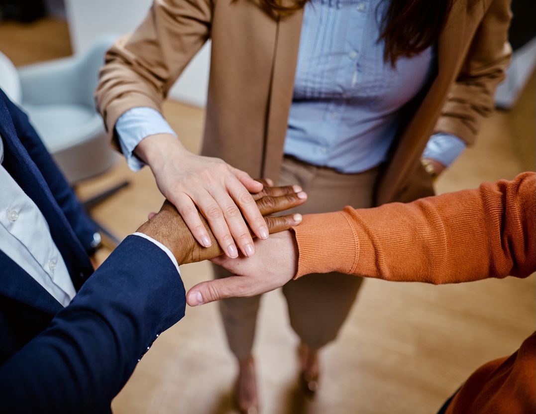 Image showing three hands linked and three logos for CIOT, ATT and TestReach, announcing new partnership to deliver excellence in digital examinations